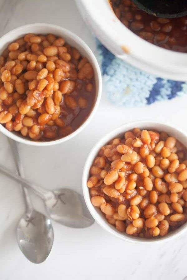 homemade baked beans in bowls with spoons