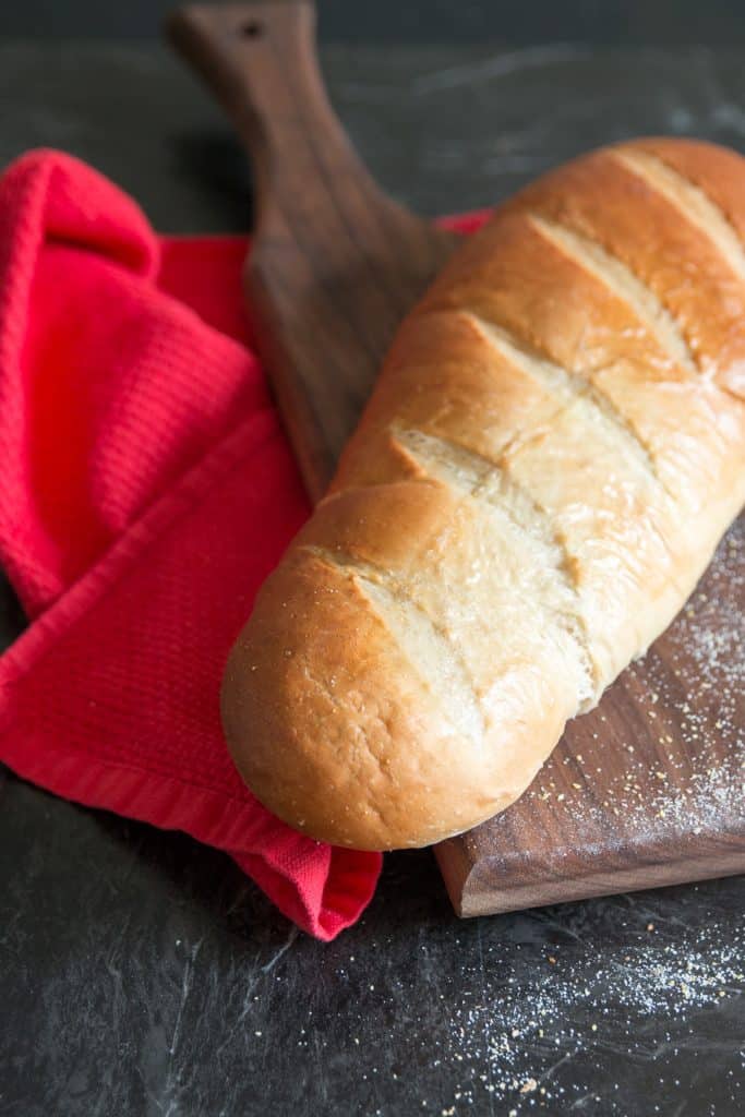 Soft french bread loaf uncut on cutting board