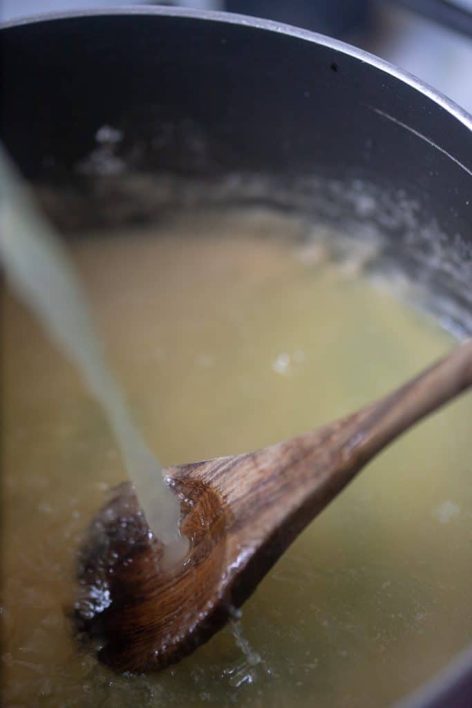 Chicken broth pouring into homemade condensed cream of chicken soup