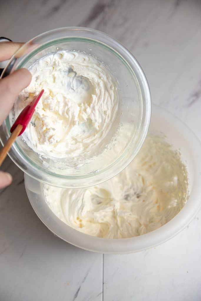 whipped cream being added to whipped cream cheese spread