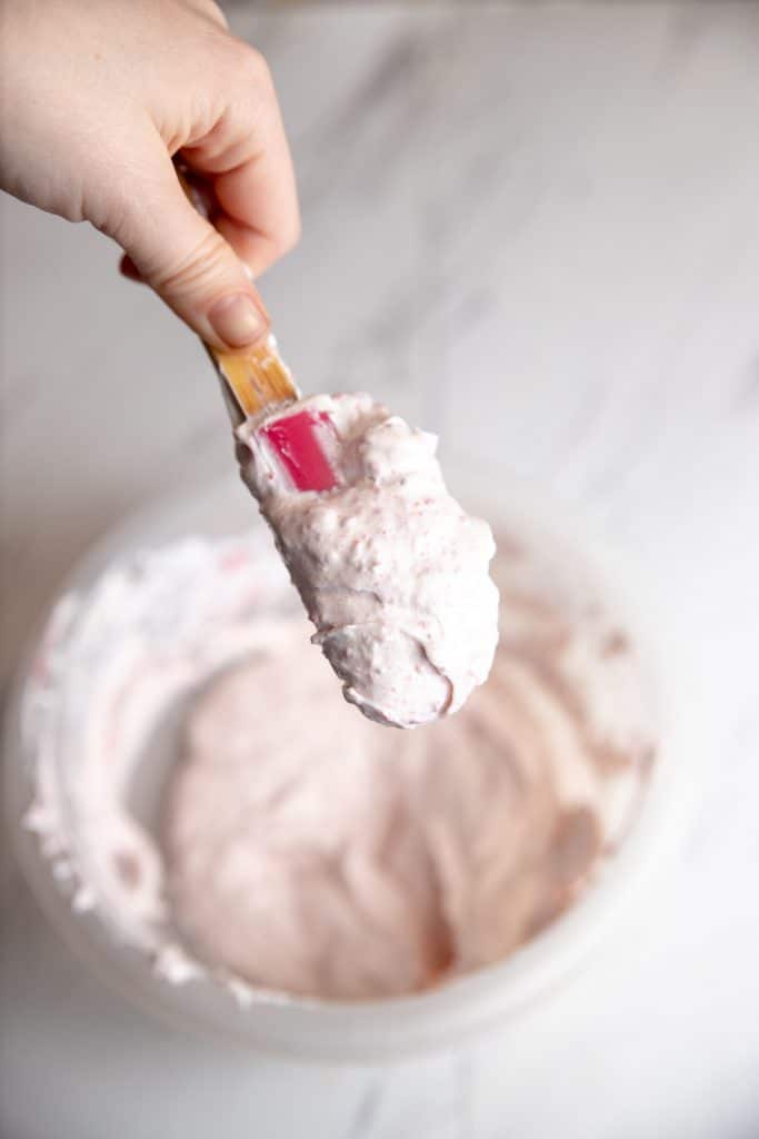 homemade strawberry whipped cream cheese spread on a spatula