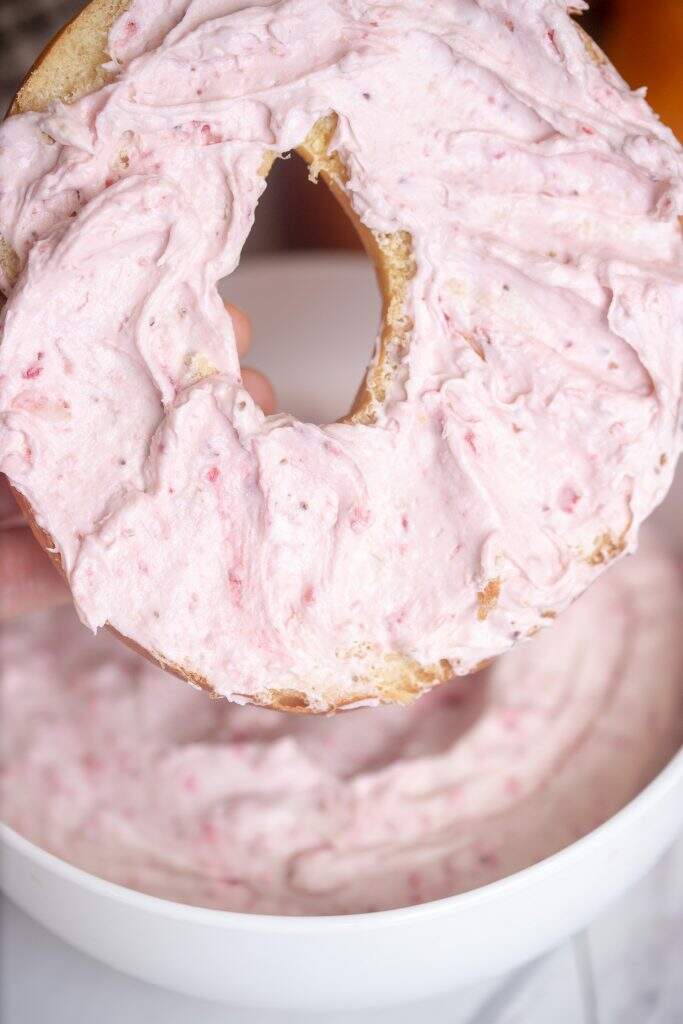 homemade strawberry whipped cream cheese spread on bagel close up