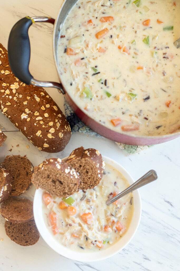 creamy chicken and wild rice soup from above with bread in bowl